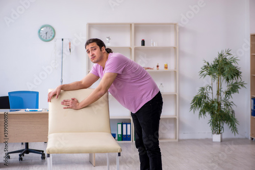 Young male patient waiting for doctor in the clinic