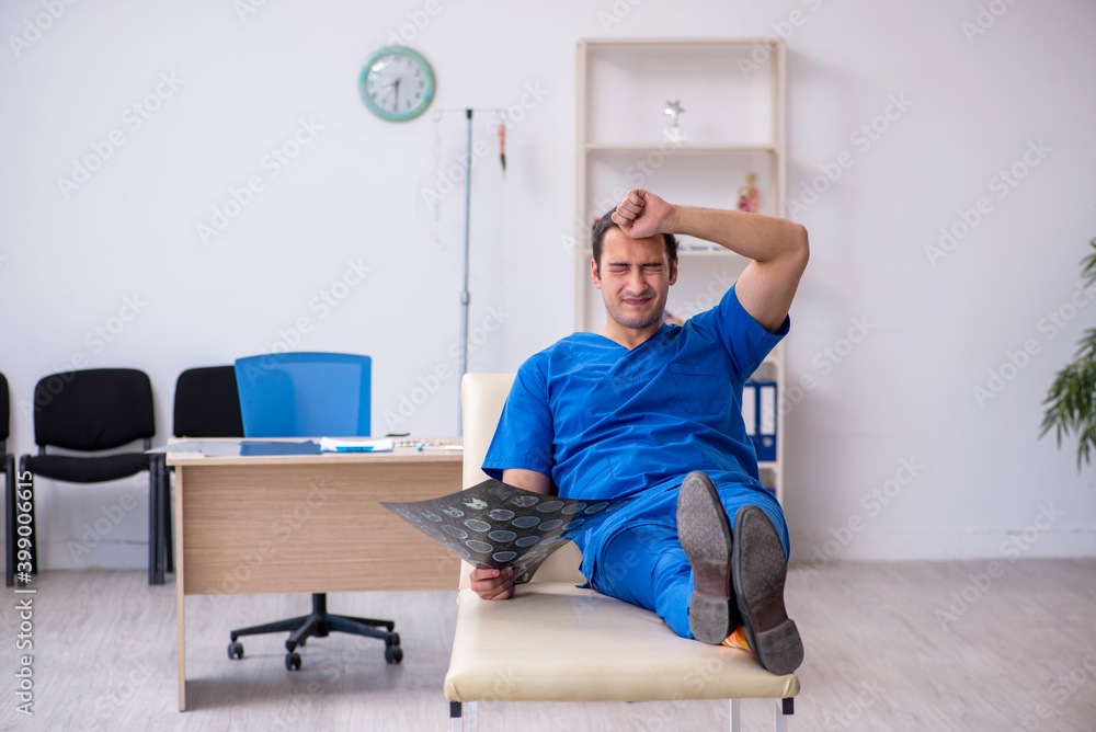 Fototapeta premium Young male doctor radiologist being unhappy after night shift