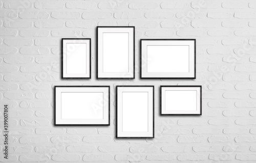 Black frames set isolated on white bricks background, six frameworks collage mock up