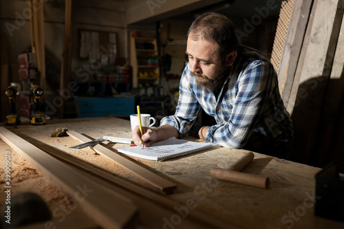 Small business carpenter working in craft studio. © 1001color