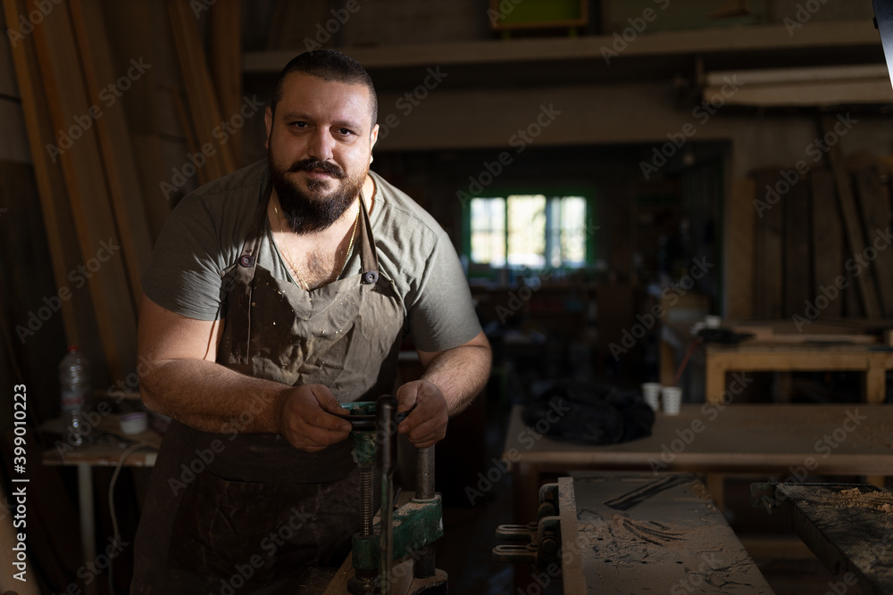 Small business carpenter working in craft studio. Small business carpenter working in craft studio.