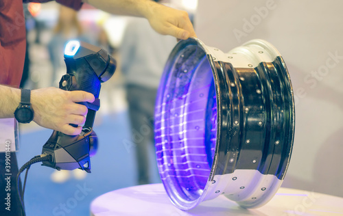 Reverse engineering concept: Engineer use portable 3d scanner scan work piece for tranfer to CAD file.