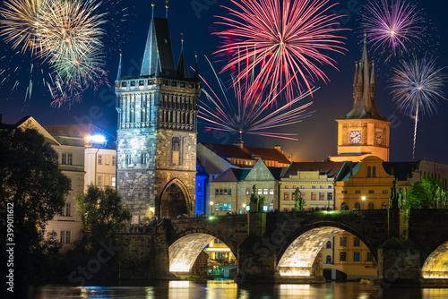 Fireworks near Charles bridge and old tower at night in Prague, Czech Republic
