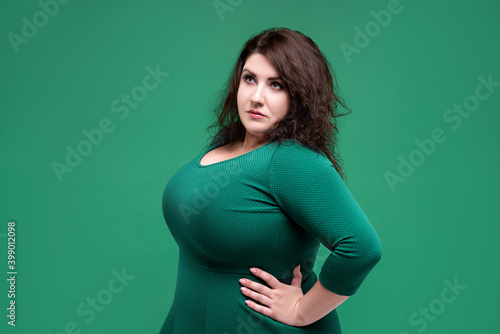 Tablou pe pânză Plus size fashion model in green dress, fat woman on green background, body posi