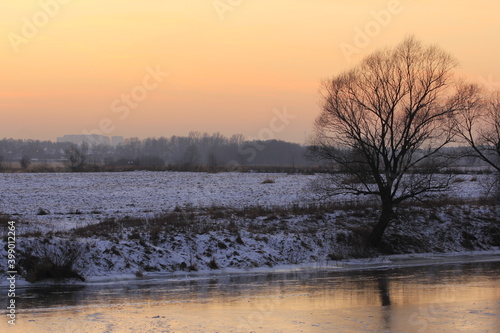 Sunset over the river in winter