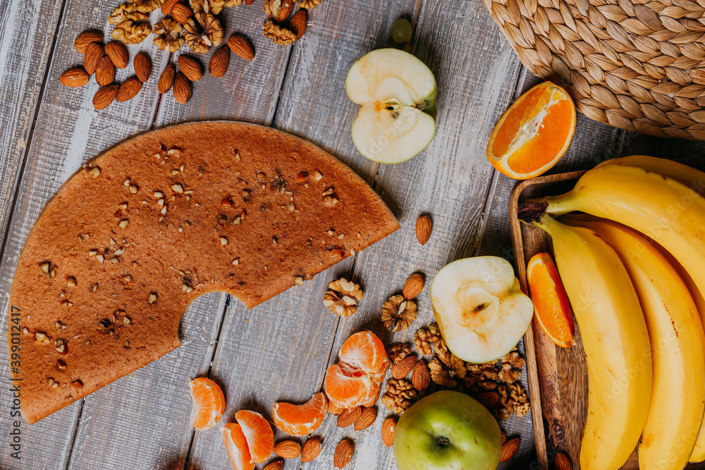 Grape fruit leather with nuts on the wooden table. Round fruit leather