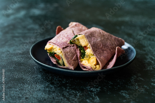 Fotografi Purple Beetroot Tortilla Flatbread Vegan Wrap with Chickpea Hummus and Spinach Leaves
