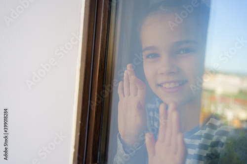 through glass. happy teen girl look out of window outside. recovered.