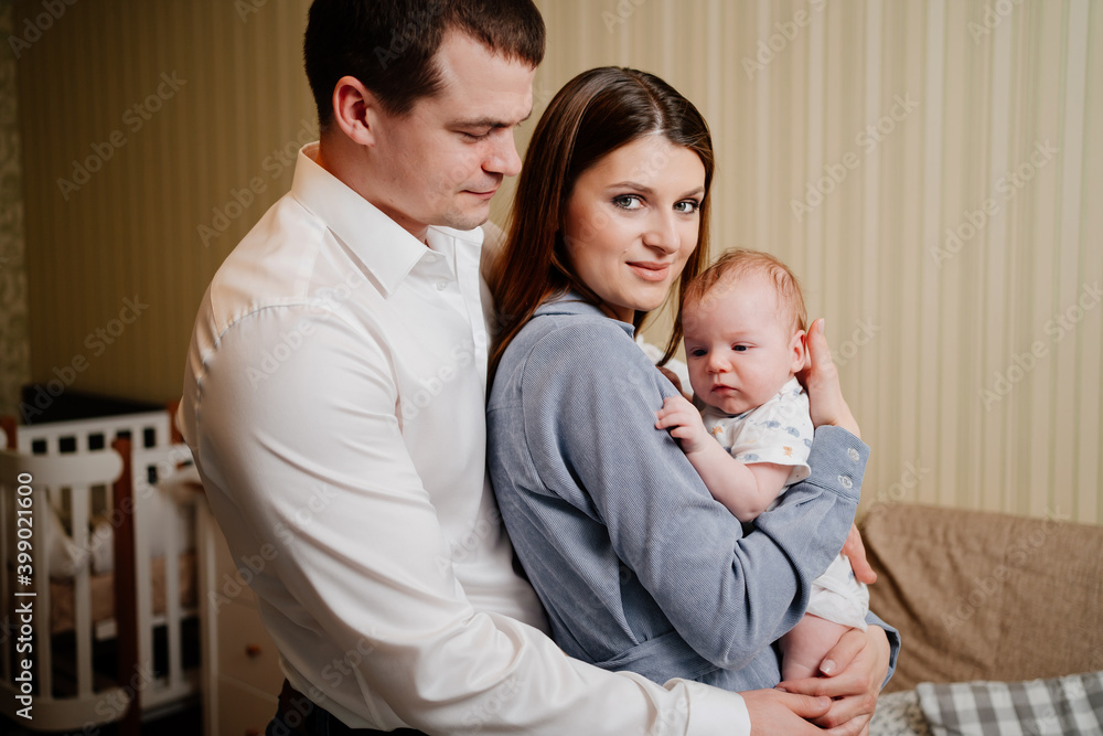 Mom and Dad hold in their arms the infant. Mom and Dad hold in their arms the infant.