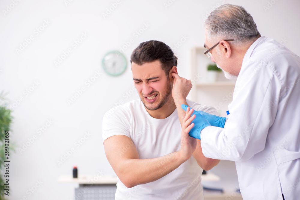 Young man visiting experienced doctor otolaryngologist Young man visiting experienced doctor otolaryngologist