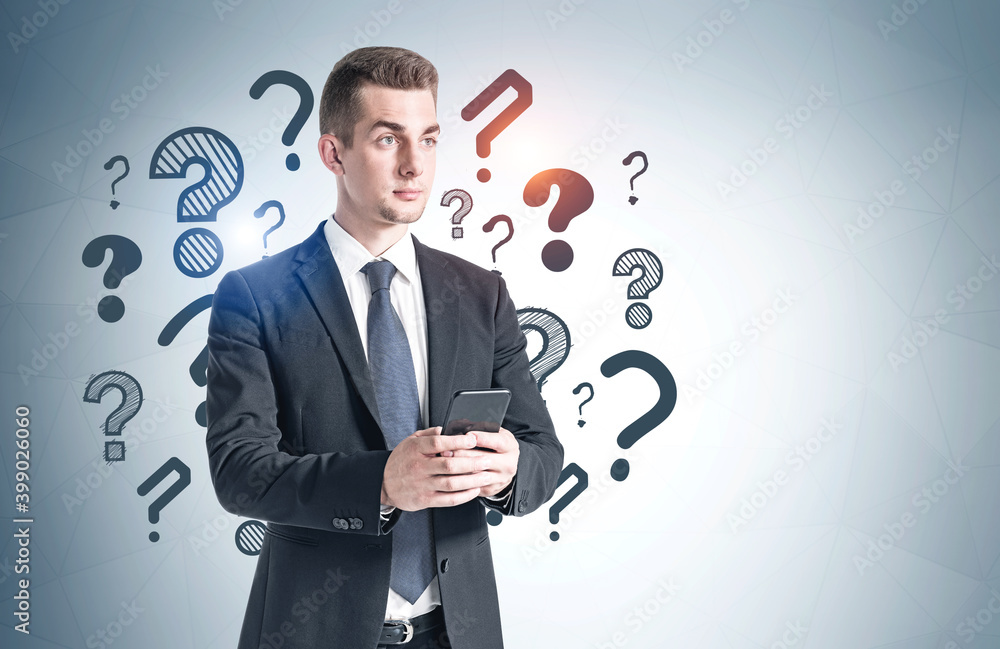 Young man with phone and question marks Young man with phone and question marks