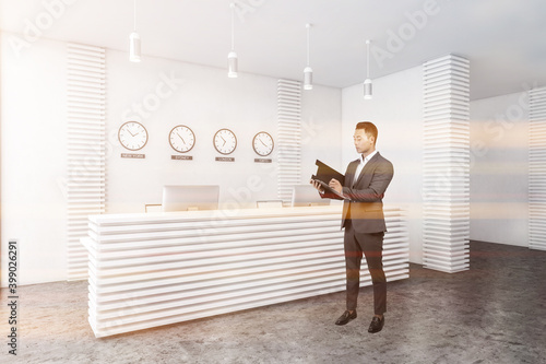 Man in white office with reception