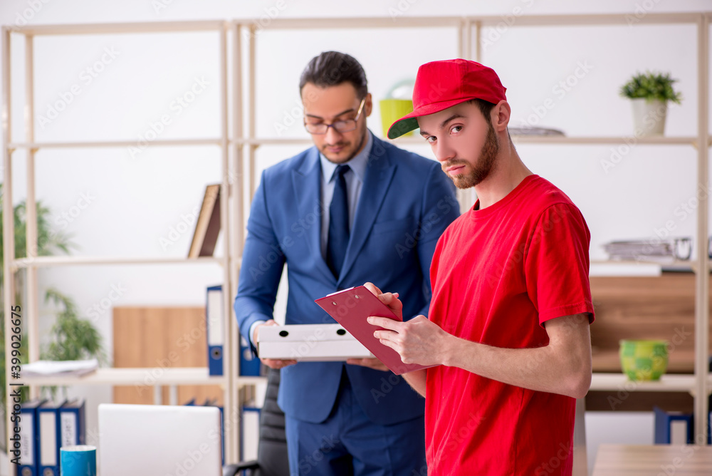 Young man delivering pizza to the office