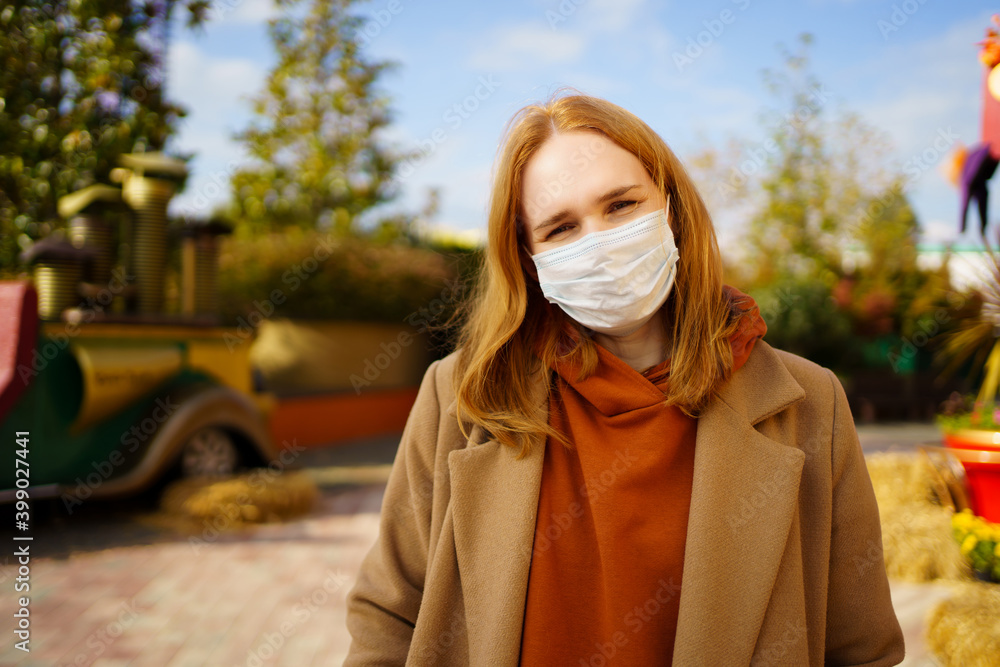 A woman in a protective mask on her face sightseeing, walking in Park. tourism A woman in a protective mask on her face sightseeing, walking in Park. tourism