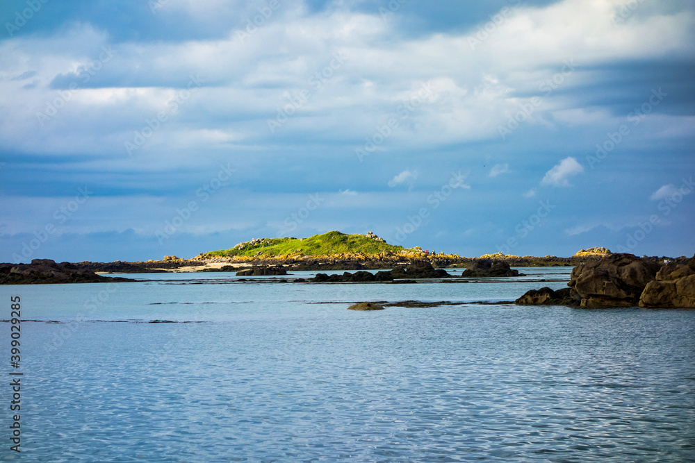 Small rocky islands on the horizon in the archipelago of Iles de Chausey. Brittany, France.