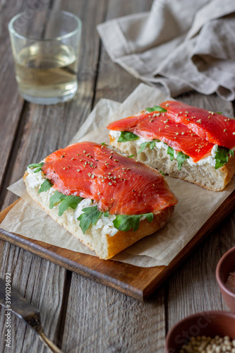 Open sandwiches with salmon, arugula and white cheese. Healthy eating.