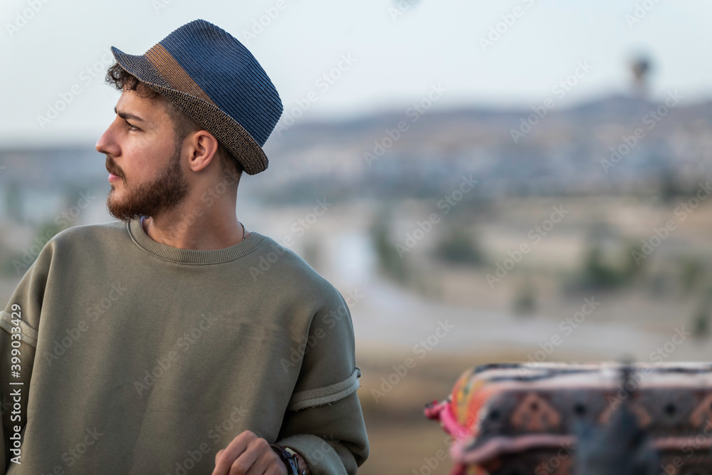 Young tourist man watching a hot air balloon tour in Cappadocia. Young tourist man watching a hot air balloon tour in Cappadocia.