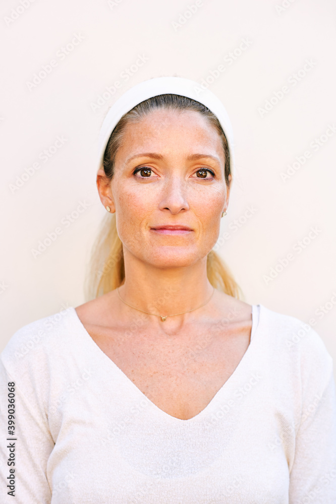 Close up portrait of mature woman wearing white clothes Close up portrait of mature woman wearing white clothes