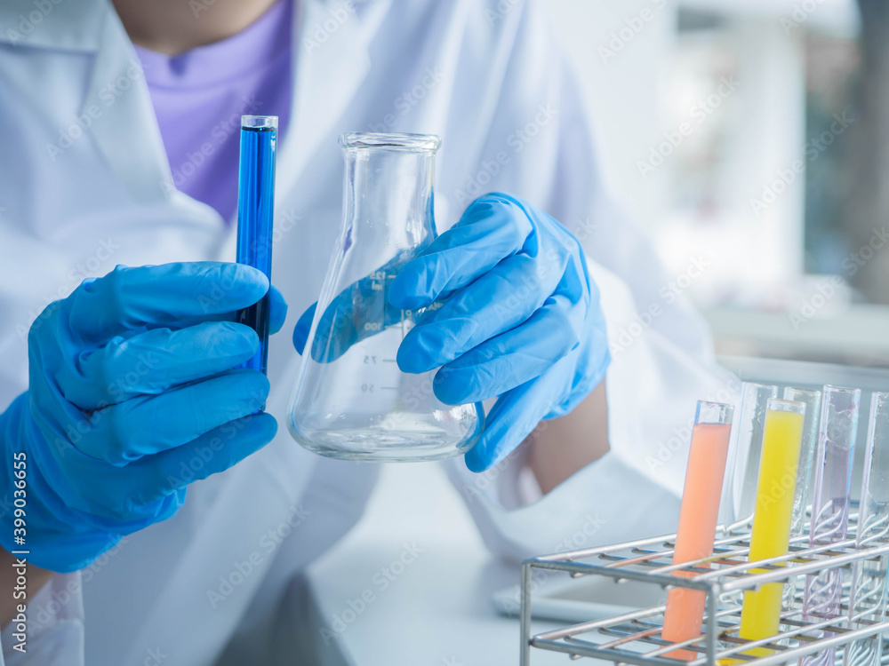 Hand of laboratory technician holding test tubes chemical tubes to do vaccine or medical research, researching in lab wearing white gown testing medicine. Hand of laboratory technician holding test tubes chemical tubes to do vaccine or medical research, researching in lab wearing white gown testing medicine.