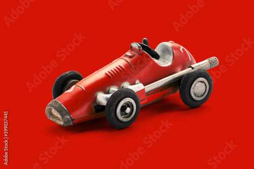 Vintage red toy racing car on red background