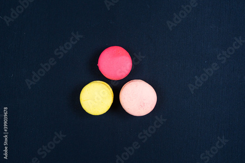 Colourful stack of macaroons isolated on plain black background.  © Tirebolux