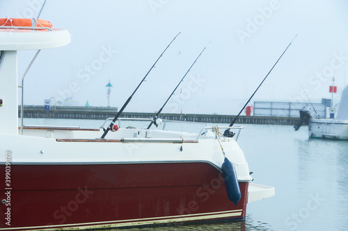 A boat with rods in the harbor