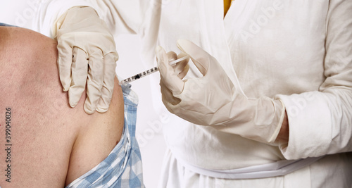 Close-up of coronavirus vaccine injection to patients with high risk of contagion. Public health campaign