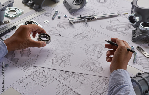 Obraz na płótnie Engineer technician designing drawings mechanical parts engineering Engine
