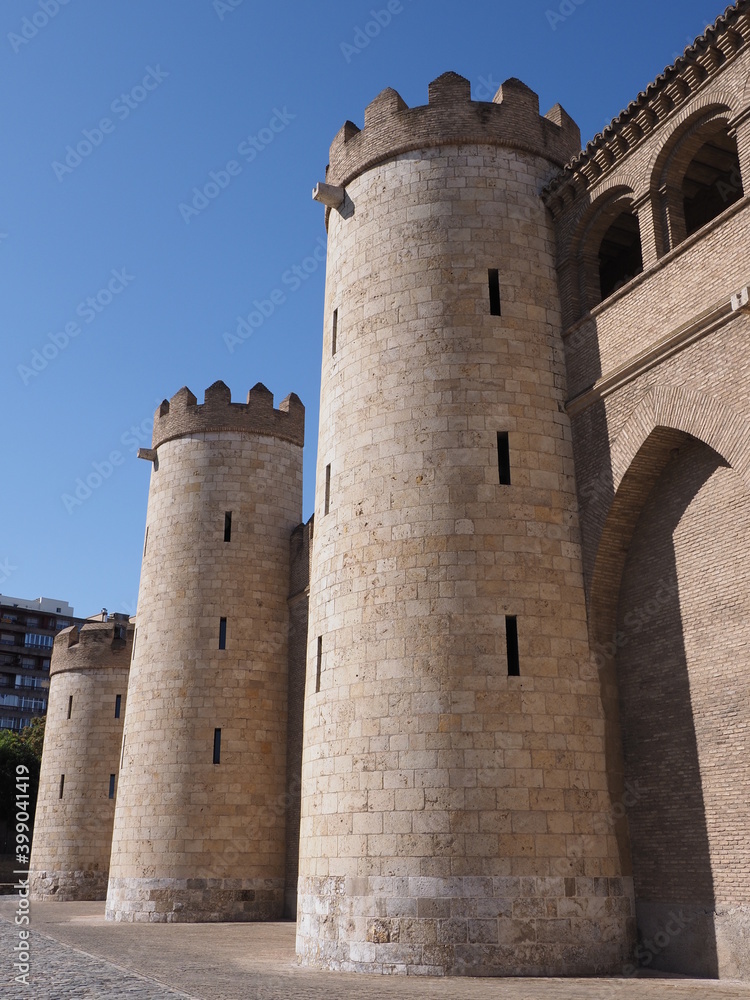 Walls of palace in european Saragossa city at Aragon district in Spain, clear blue sky in 2019 warm sunny summer day on September - vertical.