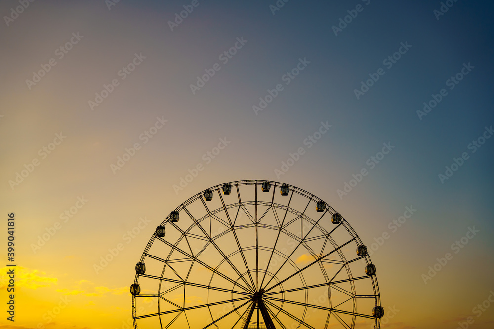 Ferris wheel against a sunset sky. entertainment for tourists.