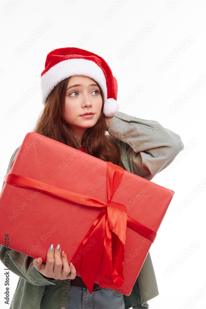 girl with a new year gift christmas hat light background girl with a new year gift christmas hat light background