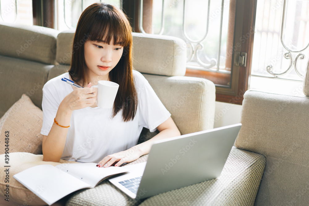 Young adult asian woman work and study at home on virus pandemic social issuse. Young adult asian woman work and study at home on virus pandemic social issuse.