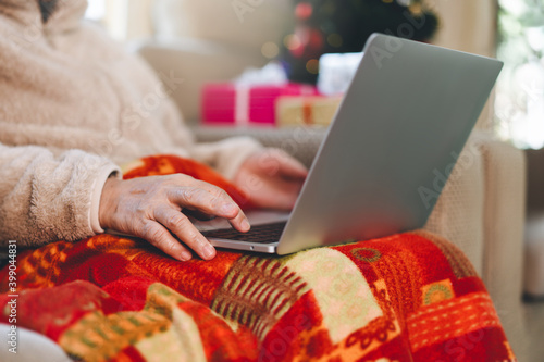 Asian elder woman lifestyle with modern technology using laptop on christmas holidays.