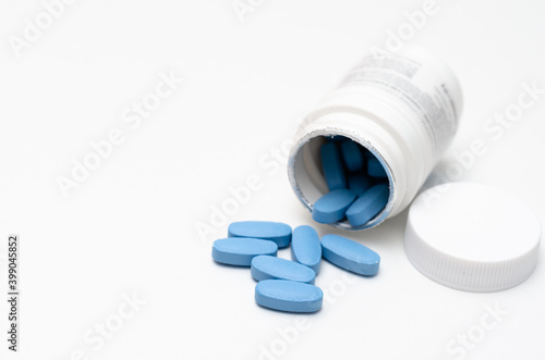 Close-up  of plastic box with blue drugs on table .