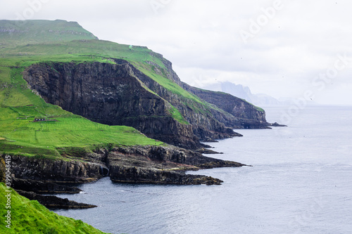 Beautiful Mykines Island with green grass landscapes and Atlantic Ocean. Mykines island, Faroe Islands, Europe.
