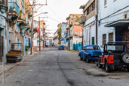 Havana Cuba Classic Cars. Typcal Havana urban scene with colorful buildings and old cars. Sunset time. © Curioso.Photography