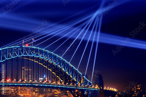 Canvas Print Sydney Harbour Bridge at night close up of lights beaming from the top of the bridge for Vivid Festival