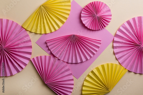 Colorful circle  paper fans on  yellow background