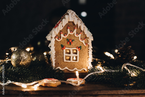 Scandinavian hygge styled Christmas composition. Cozy winter homely scene with gingerbread house for Holidays. Christmas cookies.