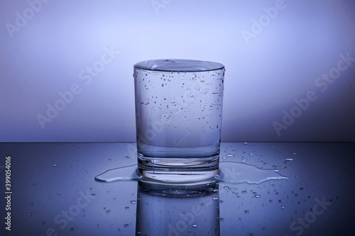 A glass with water on a blue background