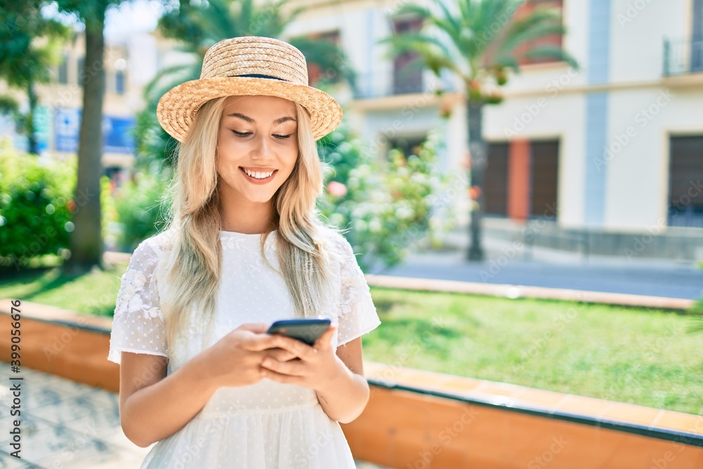Young caucasian tourist girl smiling happy using smartphone at street of city.