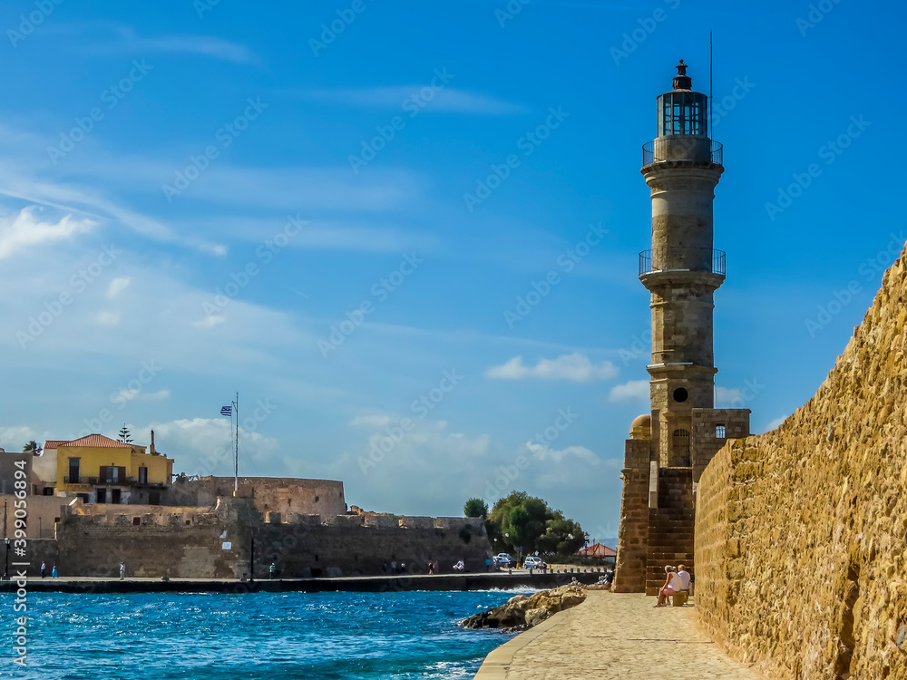 The harbour wall and lighthouse in Chania harbour, Crete on a bright sunny day