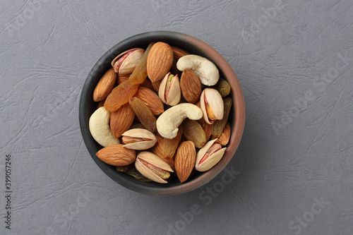Assorted nuts in a clay bowl.  photo