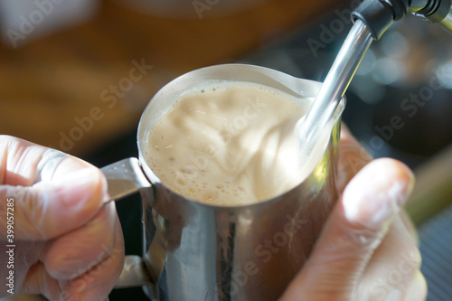 Wallpaper Mural Barista prepares a coffee drink in a pitcher using a coffee machine Torontodigital.ca