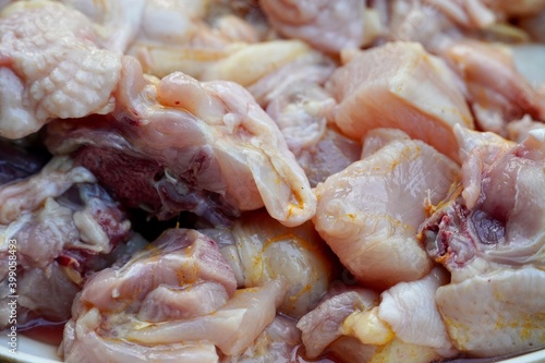 Raw chicken meat kept in a plate for sale in the market. Chicken meat chopped and kept in a plate for cooking in kitchen.