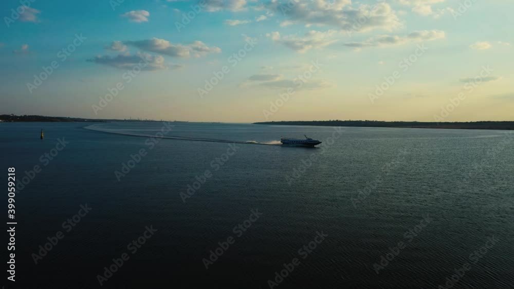 speedboat floats on the river at sunset. cuts off the surface of the water. aerial photography from a quadcopter. view from above. the boat is sailing fast along the river speedboat floats on the river at sunset. cuts off the surface of the water. aerial photography from a quadcopter. view from above. the boat is sailing fast along the river