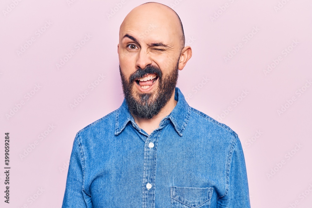 Fototapeta premium Young handsome man wearing casual clothes winking looking at the camera with sexy expression, cheerful and happy face.