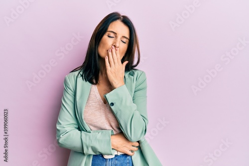 Middle age brunette woman wearing casual clothes bored yawning tired covering mouth with hand. restless and sleepiness.