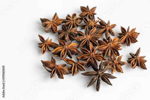 Anise stars scattered on a white background