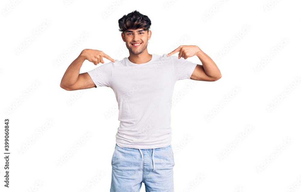 Young hispanic man wearing casual clothes looking confident with smile on face, pointing oneself with fingers proud and happy. Young hispanic man wearing casual clothes looking confident with smile on face, pointing oneself with fingers proud and happy.